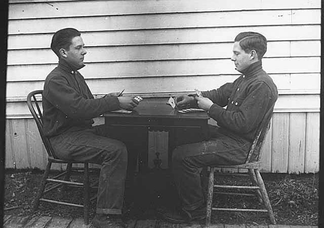 Carl Henry Moen playing cards with himself in a double exposure, Seattle, ca 1910 (MOHAI 310)