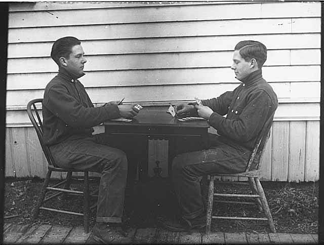 Carl Henry Moen playing cards with himself in a double exposure, Seattle, ca 1910 (MOHAI 310)
