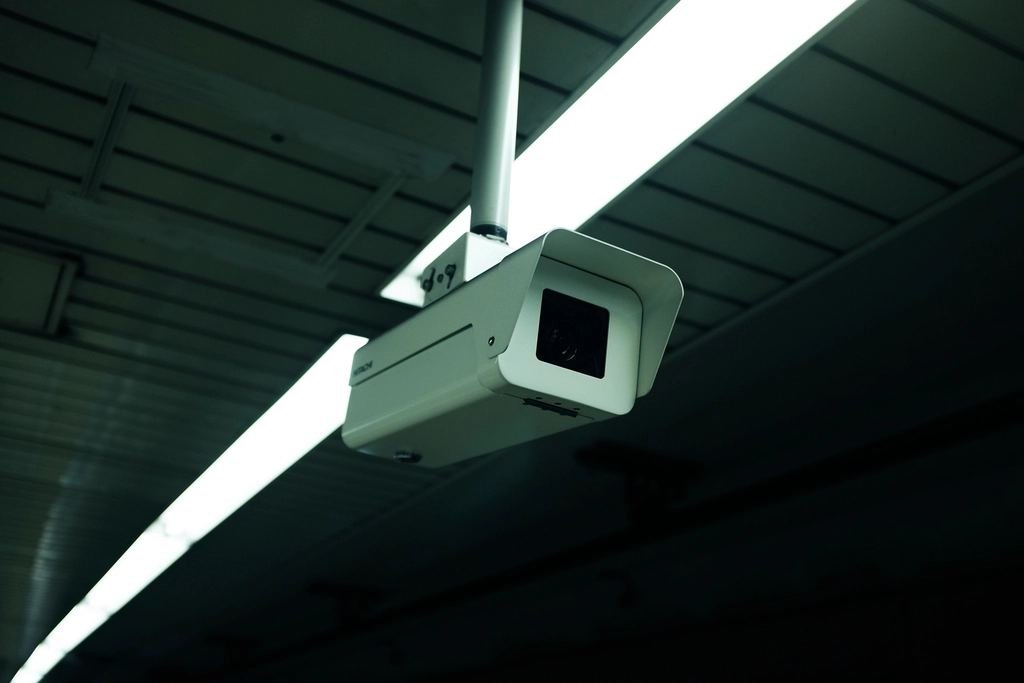 White surveillance camera monitoring dark